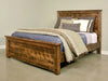 Handstone Adirondack King Panel Bed in wormy maple with a Sawmill Harvest finish, featuring a substantial framed headboard and footboard, natural wood grain with a rough-sawn textured finish, rustic character, and dark metal accents.