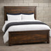 Handstone Adirondack Queen Panel Bed in wormy maple with a warm Sawmill Amber finish, featuring a substantial framed headboard and footboard, natural wood grain with a rough-sawn textured finish, rustic character, and dark metal accents.