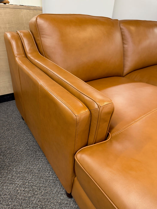 close up view of double-sloped track arms on Canadian-made top grain leather Bella sectional sofa shown in Cognac colour