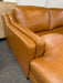 close up view of double-sloped track arms on Canadian-made top grain leather Bella sectional sofa shown in Cognac colour