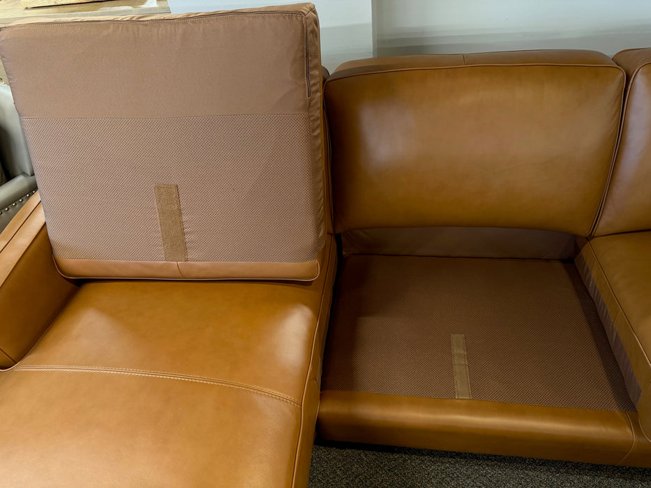 view of seat cushion opening and bottom side of Canadian-made top grain leather Bella sectional sofa shown in Cognac colour