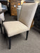 Kenova upholstered dining chair in boucle textured ivory fabric with a gently angled high back, cushioned seat, and slender tapered black metal legs.