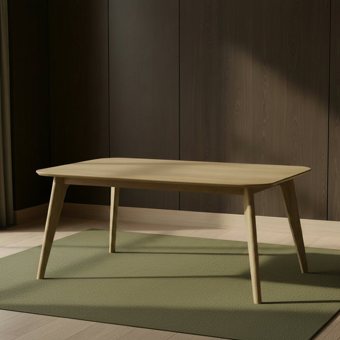 solid maple Karsjo table in a light natural finish that has a rectangular solid top with rounded corners and outward angled tapered legs