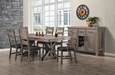 rustic dining room featuring a solid wood rectangular table with a trestle-style base, surrounded by 6 matching wooden chairs with dark upholstered seats. A coordinating sideboard sits against the wall to the right