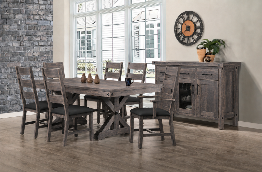 rustic dining room featuring a solid wood rectangular table with a trestle-style base, surrounded by 6 matching wooden chairs with dark upholstered seats. A coordinating sideboard sits against the wall to the right