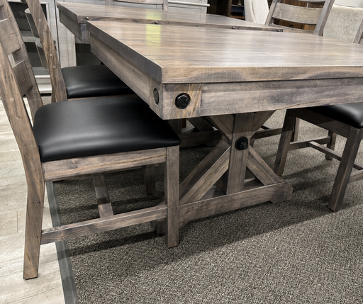 rustic dining table featuring a trestle-style base, and matching wooden chairs with dark upholstered seats